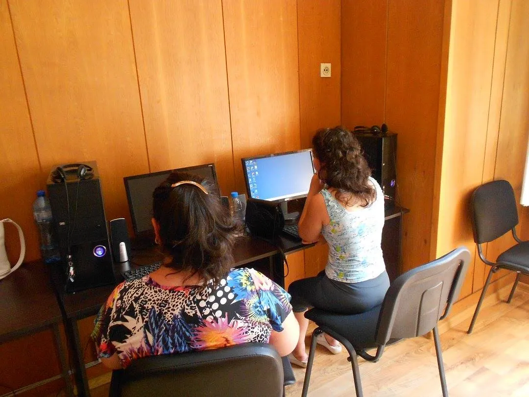 Women practising computer skills in the training room of the Centre